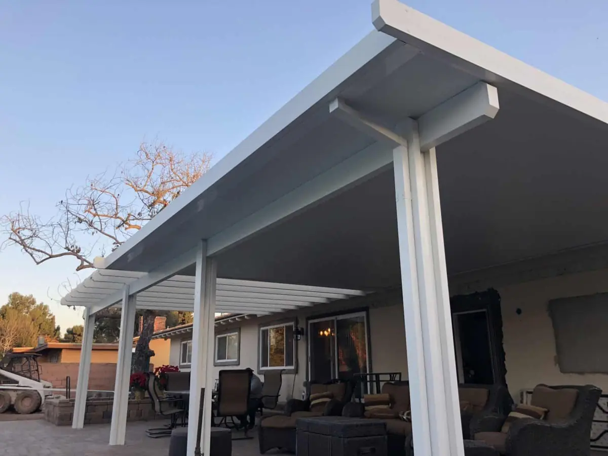White solid patio cover shading an outdoor seating area
